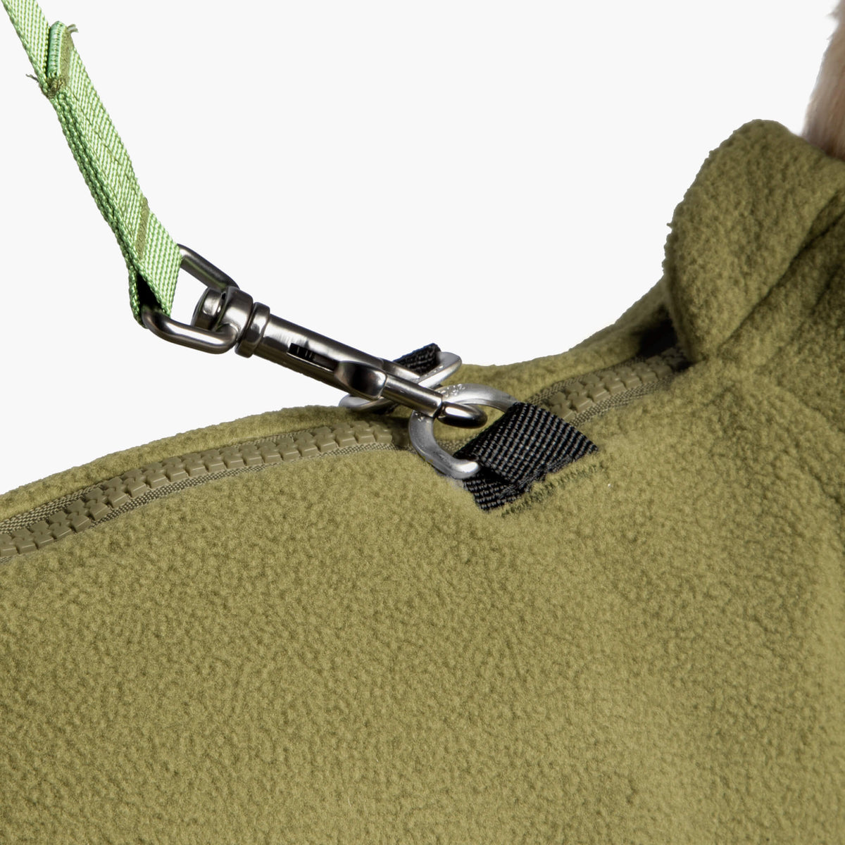 Close-up of an olive fleece vest zipper and matching leash attachment