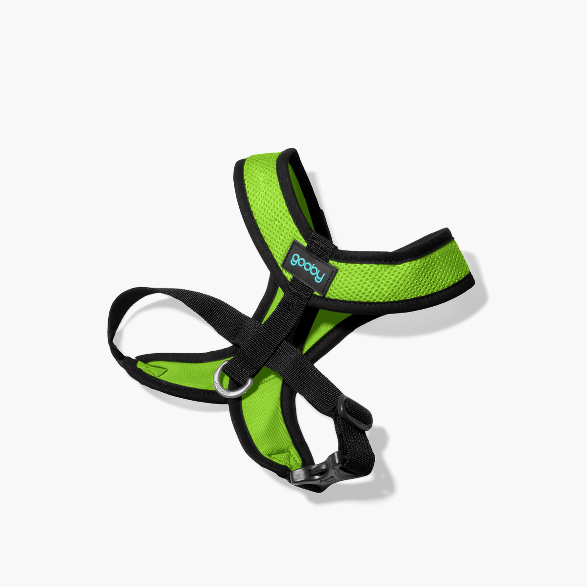 Green Comfort X harness with black trim, shown angled on a white floor