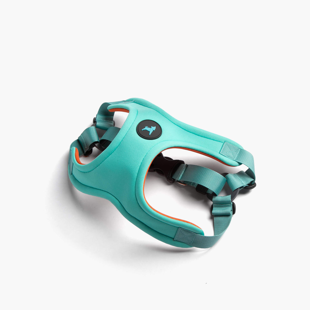 Angled view of a mint Escape Free sport harness with teal straps and orange trim