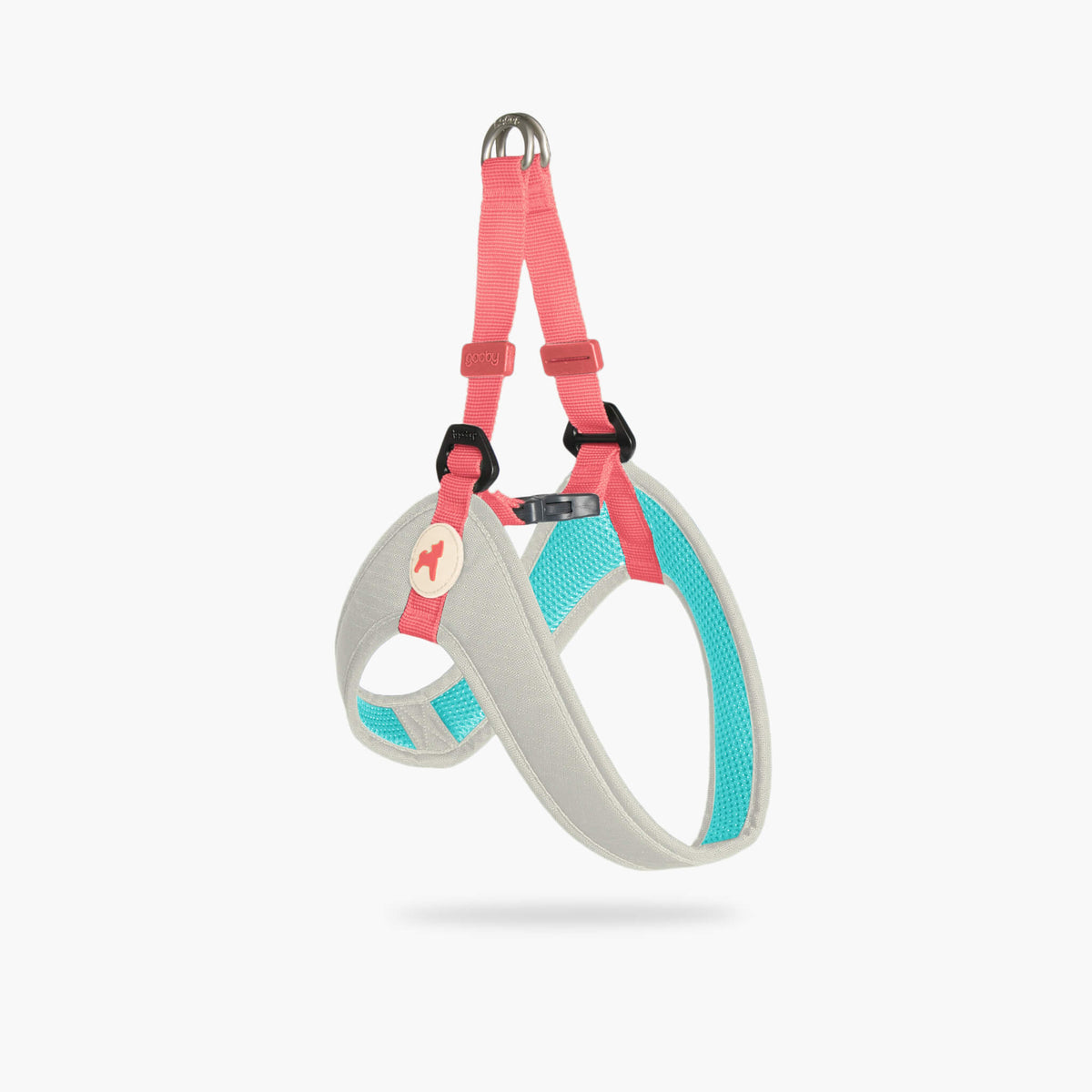 Angled view of a cream step-in dog harness with pink straps and turquoise accents