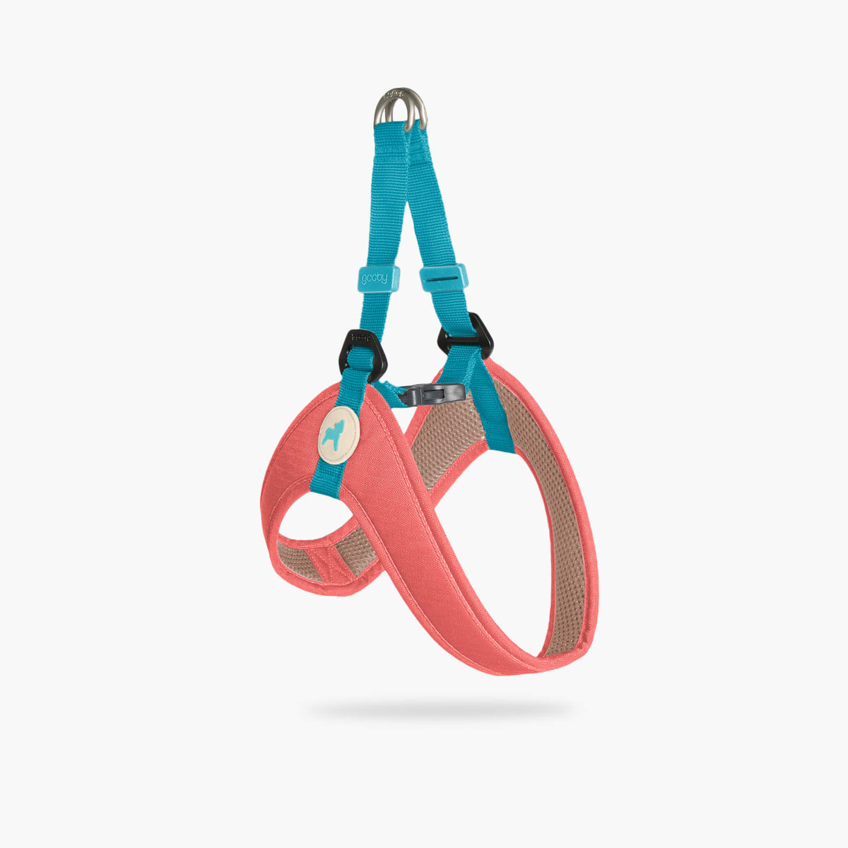Angled view of a solid pink step-in harness with turquoise straps