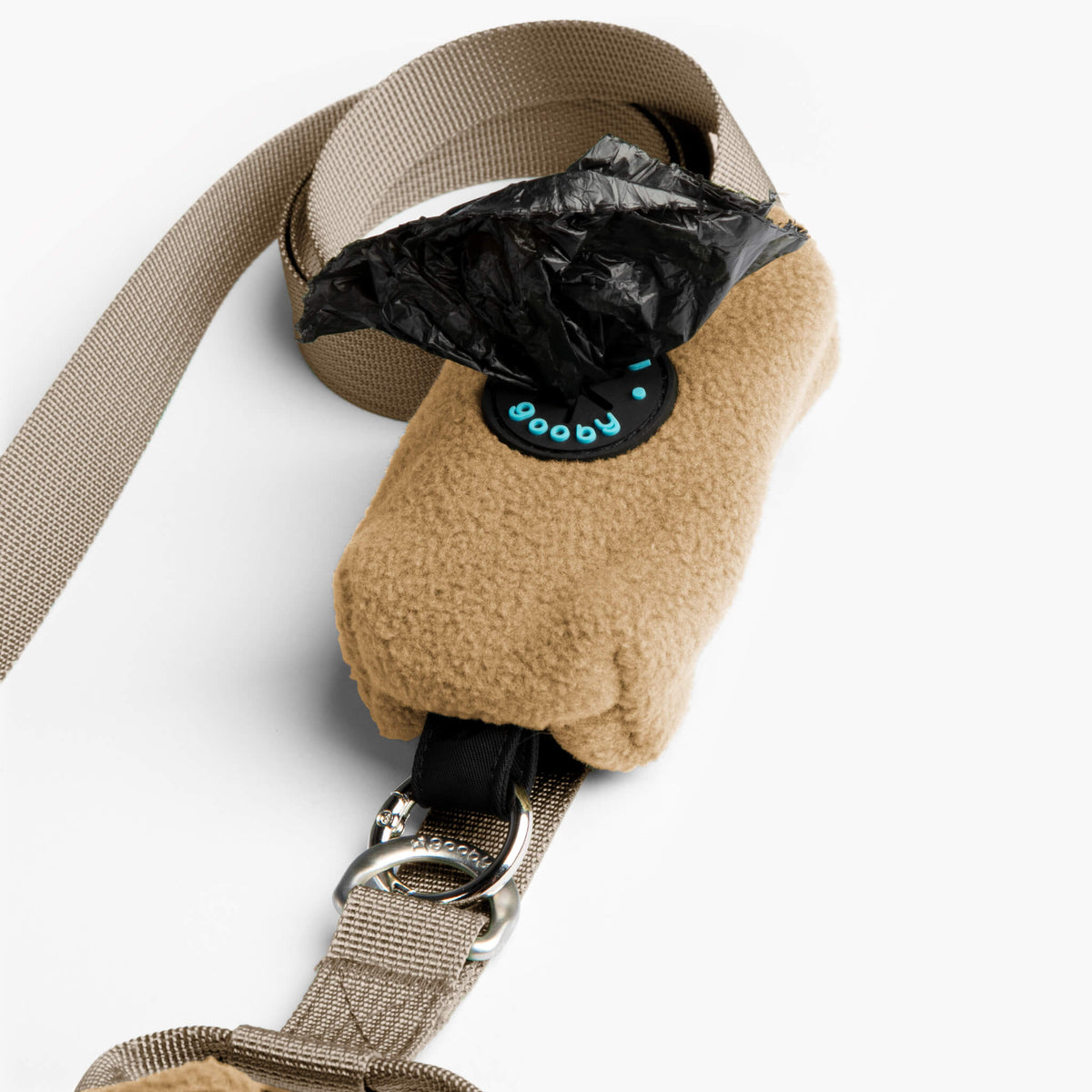 Close-up of a beige fleece dog vest with matching leash and metal clip