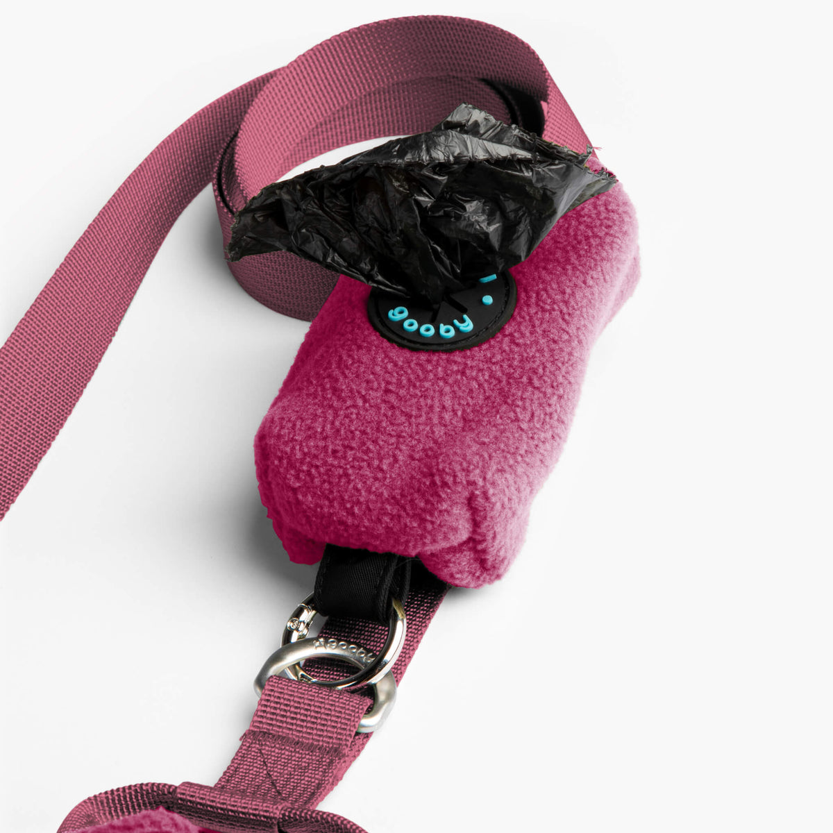 Close-up of a magenta fleece vest with matching leash, buckle, and black zipper detail