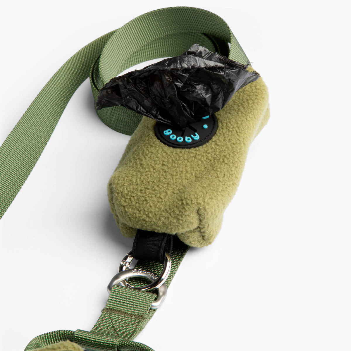 Close-up of an olive fleece vest with matching green leash and metal clip