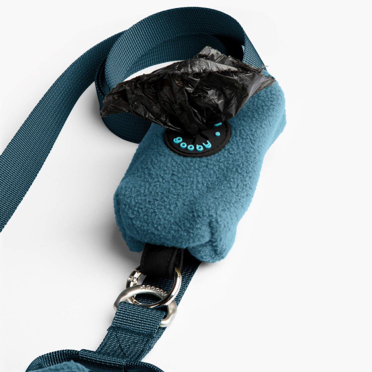 Close-up of a blue fleece vest with matching leash, buckle, and black waste-bag pouch