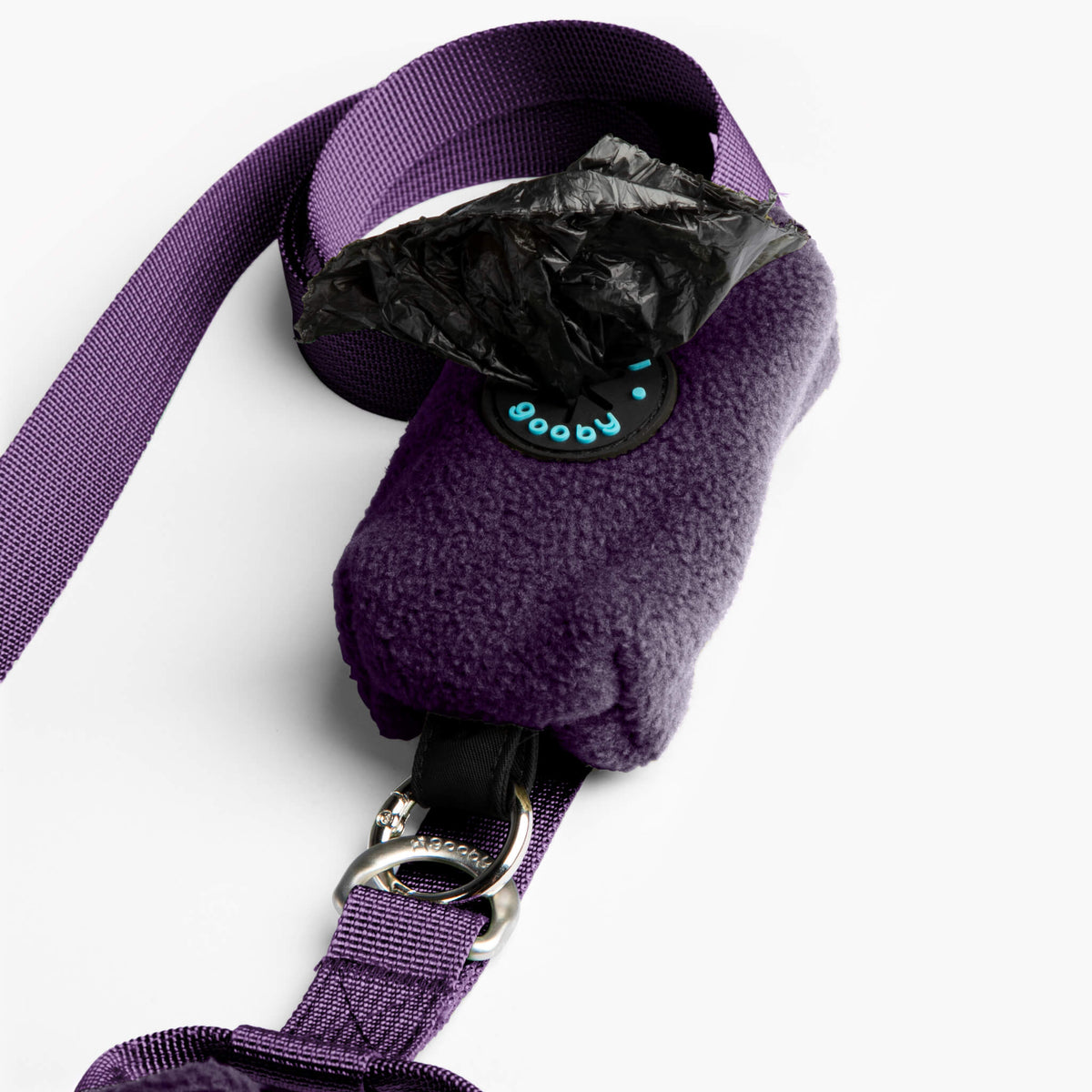Close-up of a purple fleece vest with an attached matching leash and metal clasp