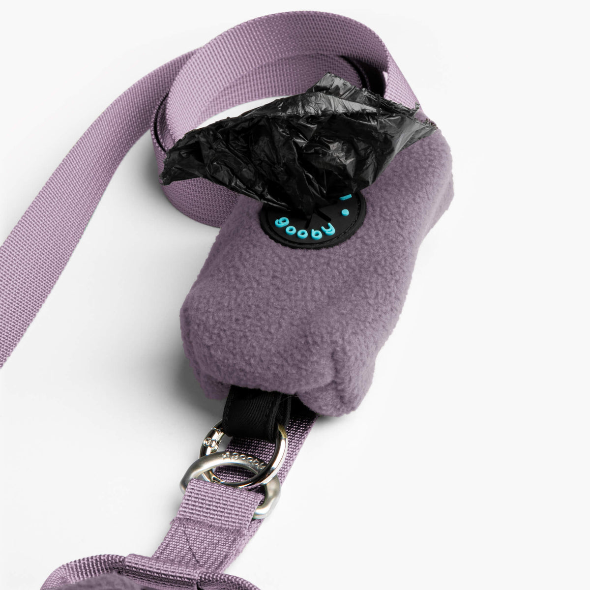 Close-up of a lavender fleece dog vest with matching leash and metal buckle