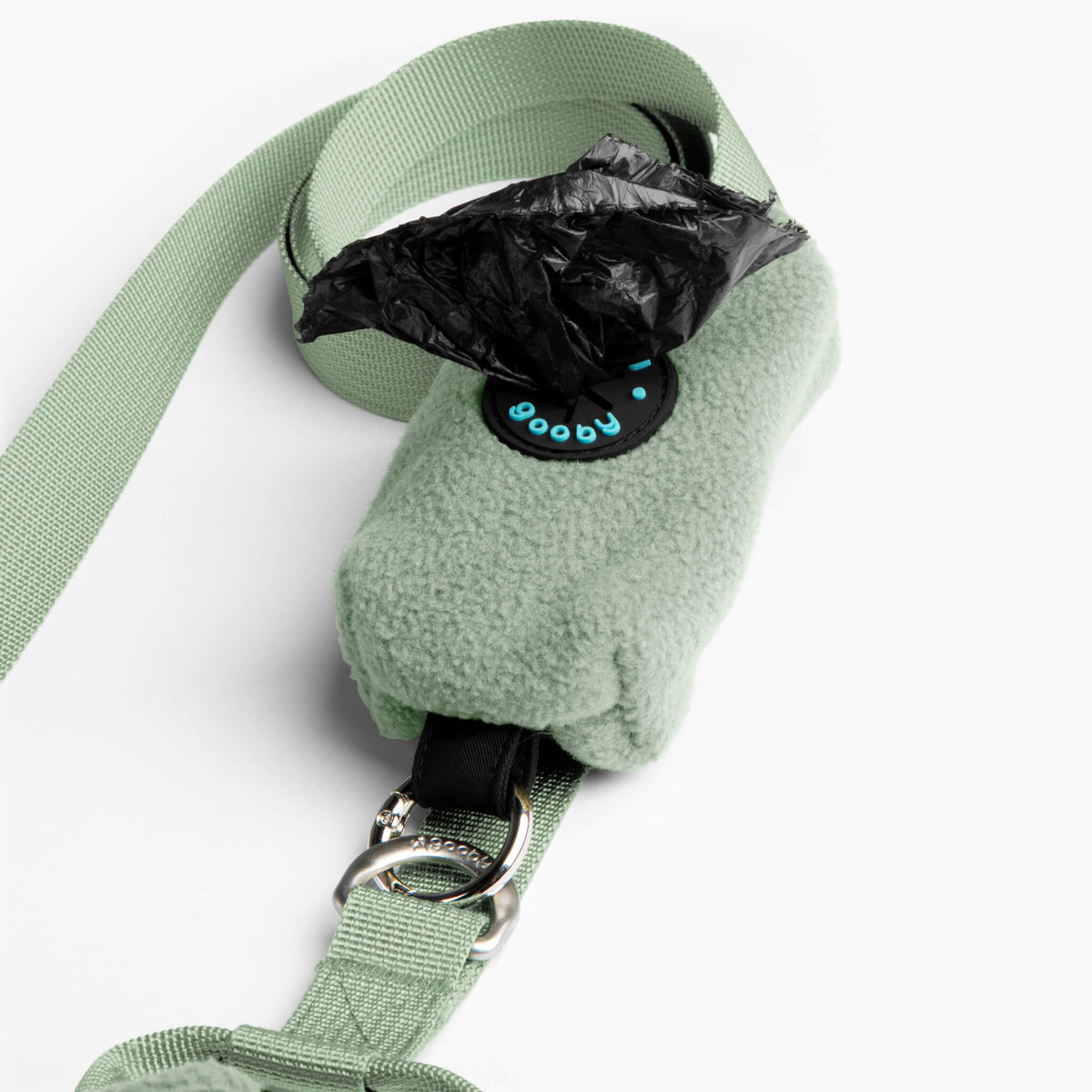 Close-up of a mint fleece vest matching leash with a metal clip and waste-bag dispenser