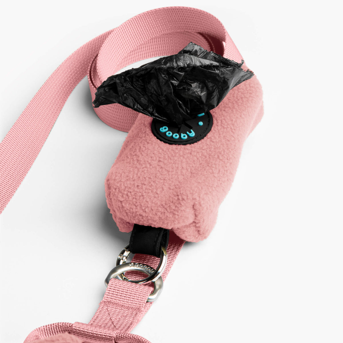 Close-up of a pink fleece vest with a matching leash and metal hardware