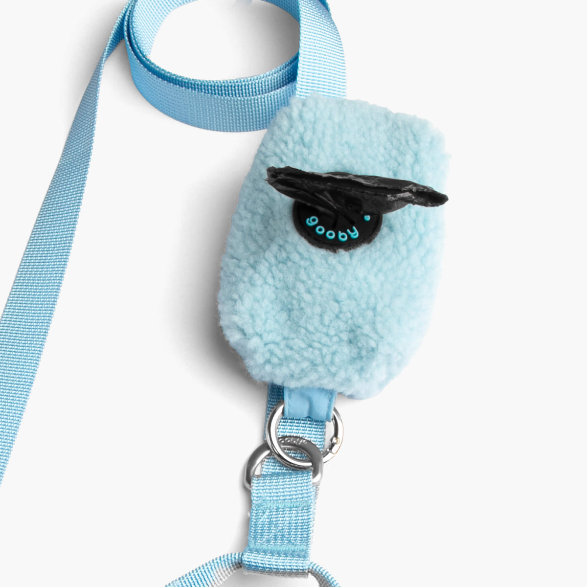 Close-up of a baby blue sherpa pouch and matching leash with silver hardware