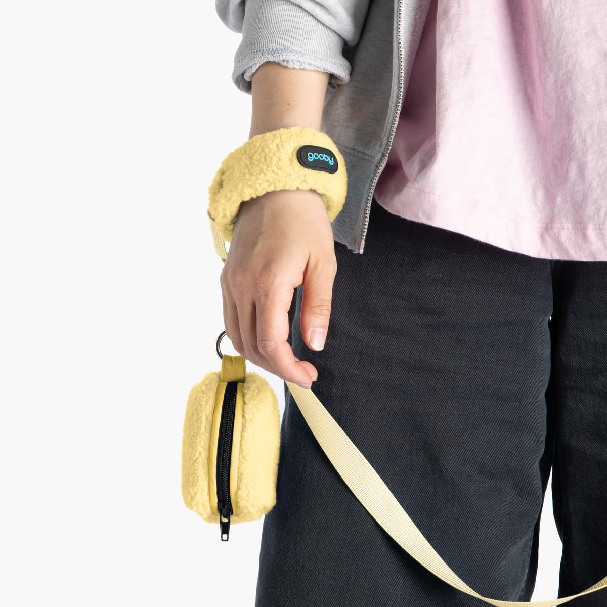 Butter Yellow sherpa wristband leash and matching zip pouch shown on a person