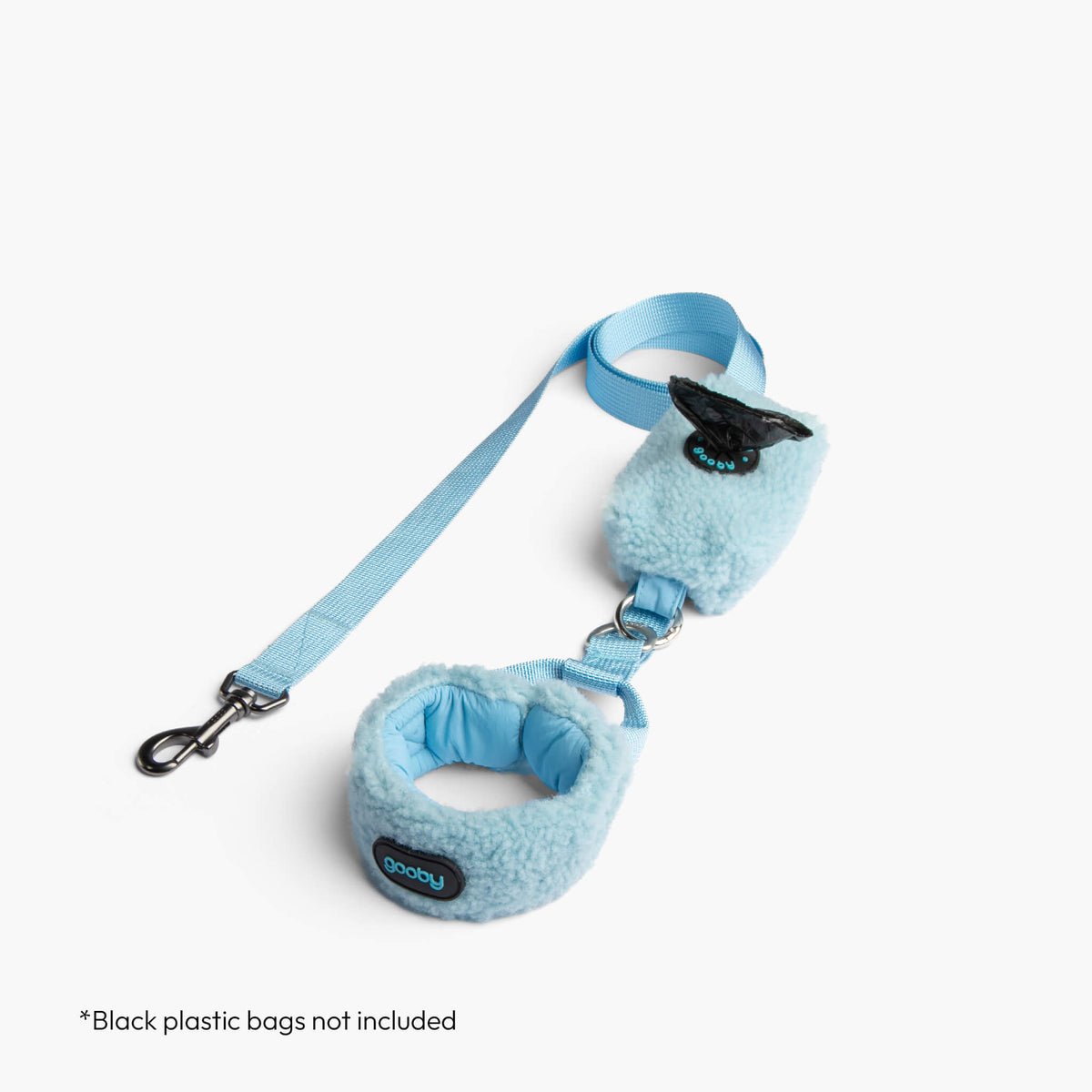 Baby blue sherpa puffer vest with matching leash, shown with a black waste-bag dispenser