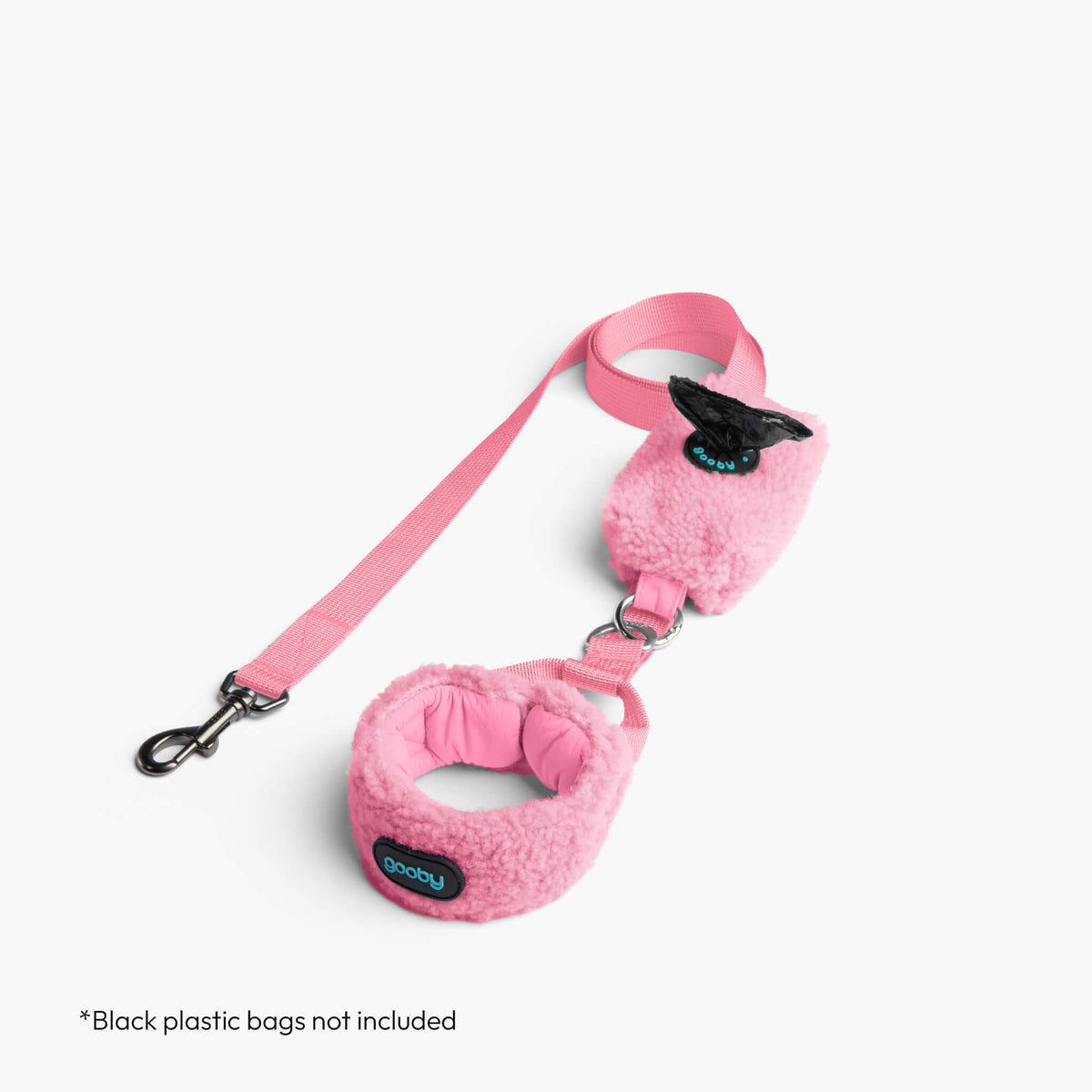 Baby pink sherpa puffer vest with matching leash; black plastic bags not included.