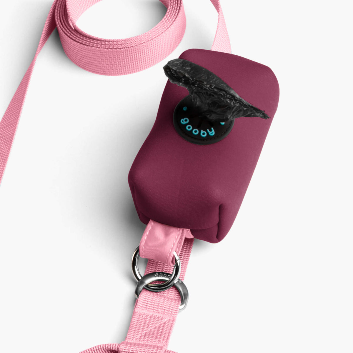 Close-up of a baby pink matching leash with a padded burgundy handle and metal rings