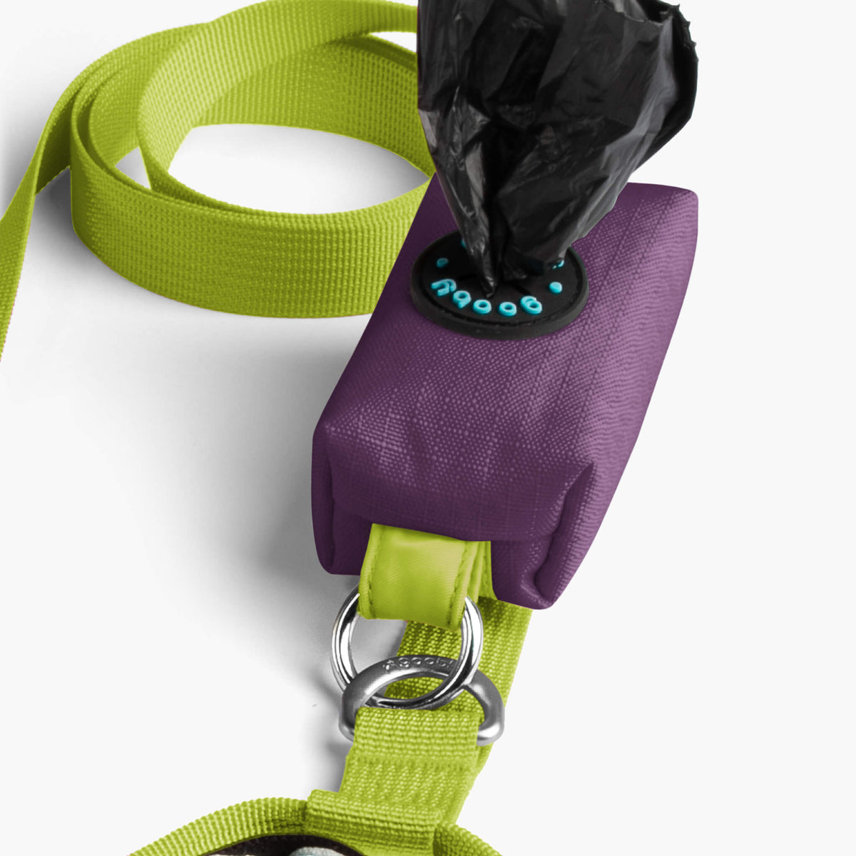 Close-up of a purple step-in harness with a bright green matching leash and metal rings