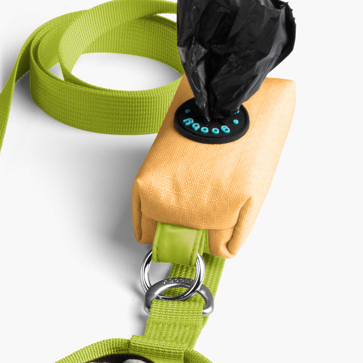 Close-up of a padded yellow matching leash with a bright green strap and metal rings
