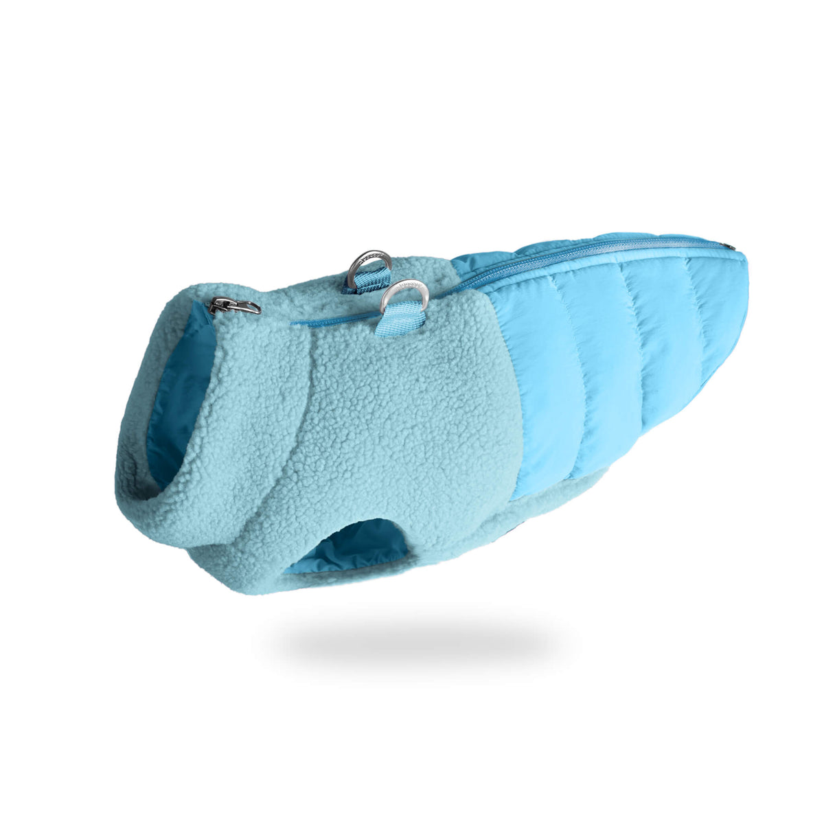 Angled view of a baby blue sherpa-lined puffer vest for dogs