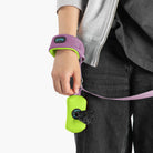Close-up of a lavender wrist leash with a purple wristband and bright green accessory pouch