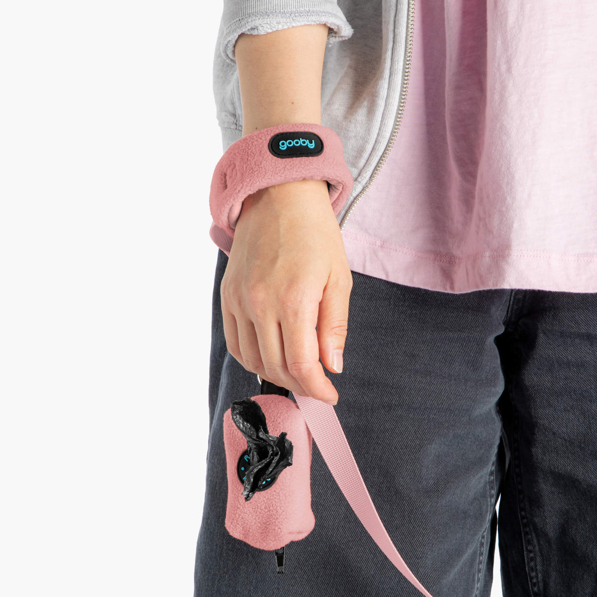 Close-up of a pink fleece wristband leash and matching waste-bag pouch