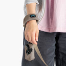 Close-up of a person wearing a warm gray fleece set with a matching leash accessory