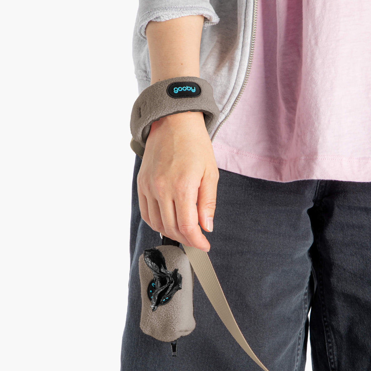 Close-up of a person wearing a warm gray fleece set with a matching leash accessory