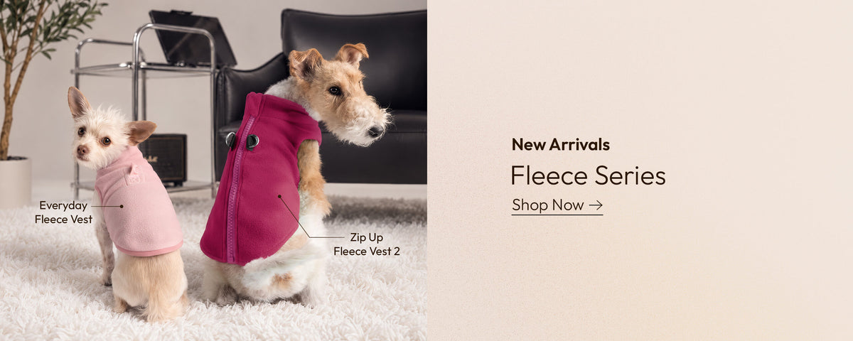 Two dogs wear fleece sweaters beside text reading “New Arrivals Fleece Series Shop Now.”