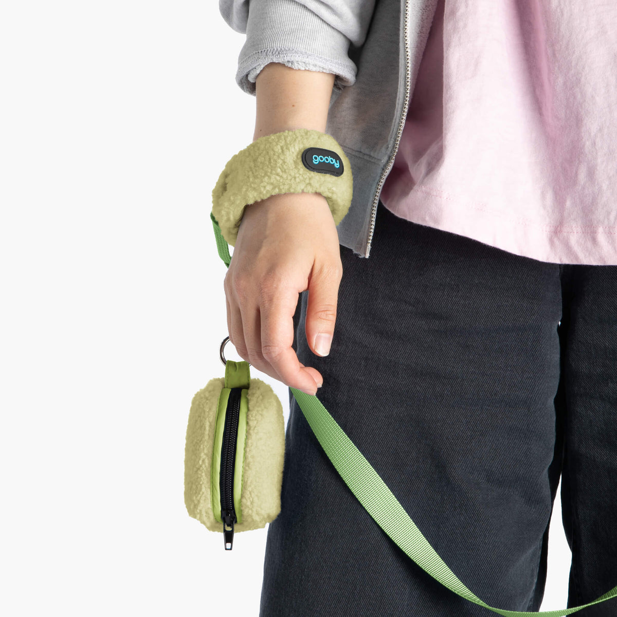 Close-up of an avocado sherpa wristband leash and matching zippered accessory pouch