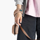 Close-up of a mocha sherpa wristband leash with a matching zippered pouch