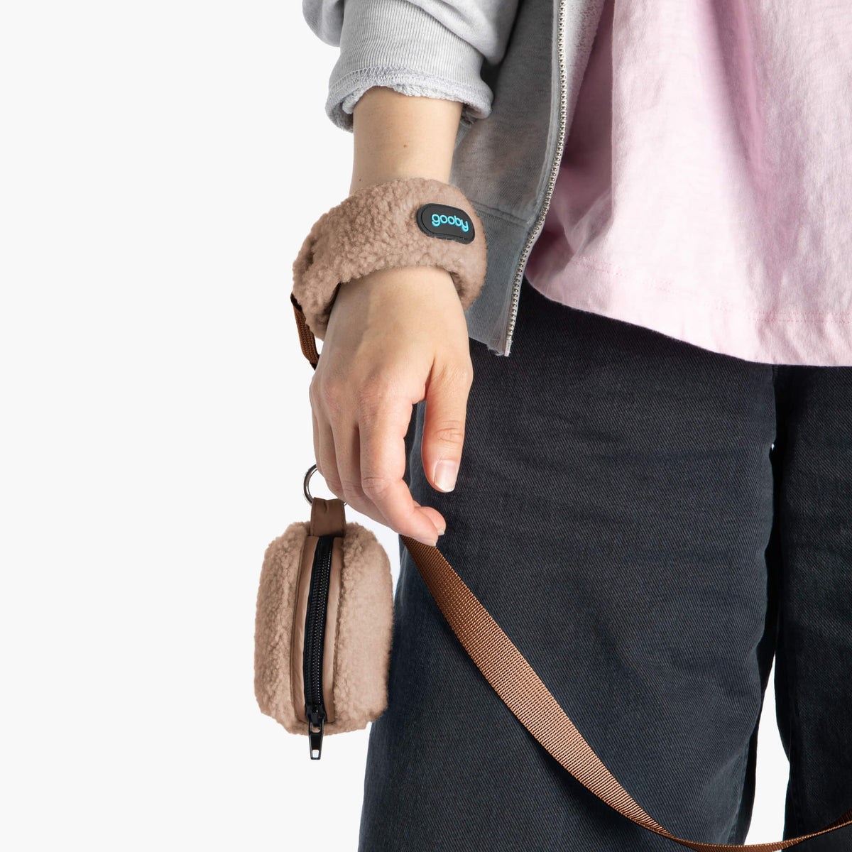 Close-up of a mocha sherpa wristband leash with a matching zippered pouch