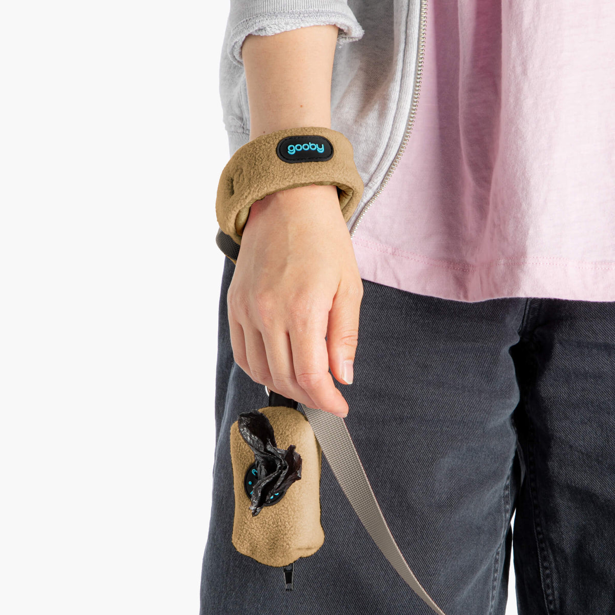 Close-up of a beige fleece vest set's matching wrist leash and cuff