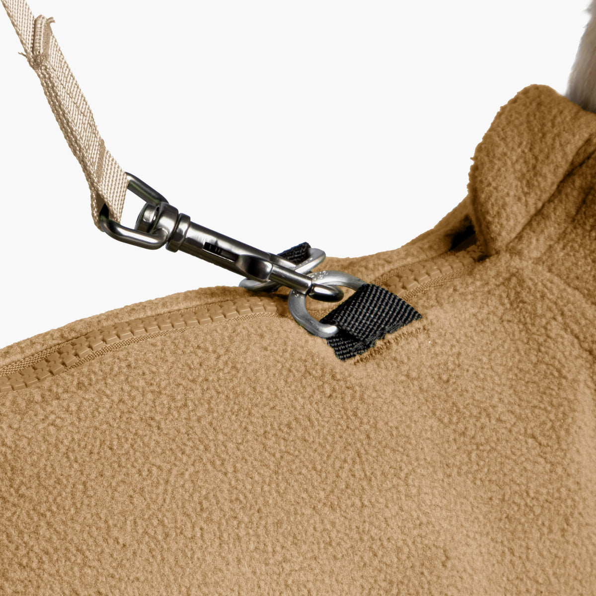 Close-up of the beige fleece vest zipper and leash attachment