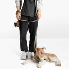 Person walking a dog wearing a beige fleece vest and matching leash