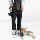 Person and wire-haired dog wearing a matching blue walking set