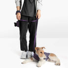 Person and wire-haired dog wearing matching purple fleece accessories